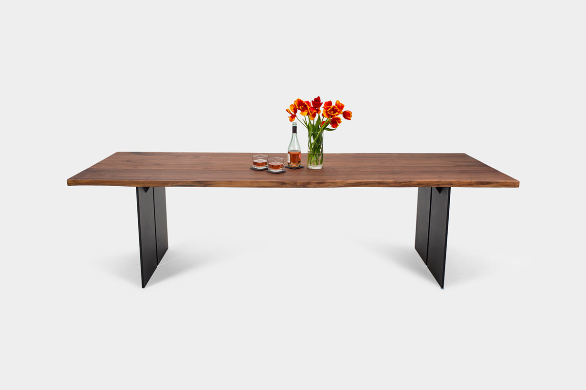 Industrial meets organic with steel and warm wood contrast.